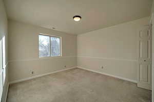 Spare room featuring light colored carpet