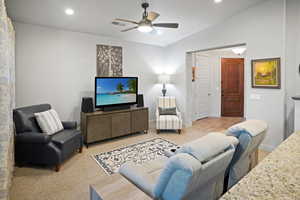 Great room featuring ceiling fan and vaulted ceiling