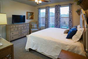 Carpeted bedroom with ceiling fan