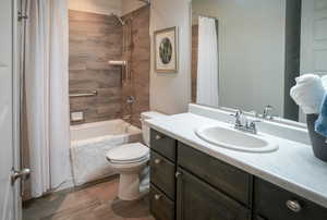 Full bathroom with shower / bath combination with curtain, toilet, and vanity