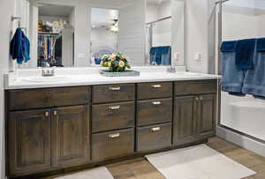 Owner's bathroom, featuring dual vanities, and an enclosed shower.