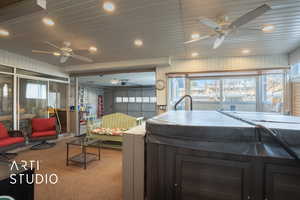 Kitchen featuring ceiling fan and carpet floors