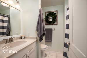 Bathroom featuring tile patterned floors, vanity, and toilet