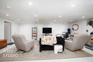 Carpeted living room with a textured ceiling