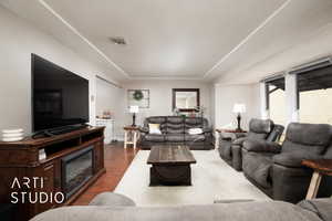 Living room with dark hardwood / wood-style flooring