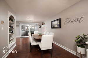 Dining space featuring built in shelves and dark hardwood / wood-style floors