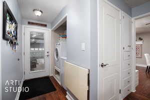 Laundry area with a textured ceiling, dark wood-type flooring, and washer / clothes dryer