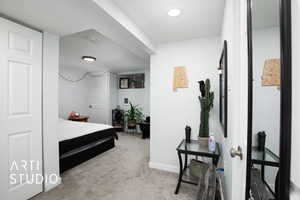 Bedroom featuring light colored carpet and a textured ceiling