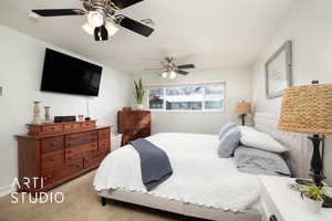 Bedroom with ceiling fan and light colored carpet