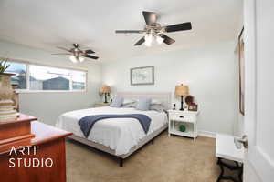 Bedroom featuring ceiling fan and light colored carpet