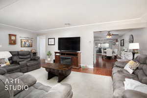 Living room featuring ceiling fan and dark hardwood / wood-style flooring