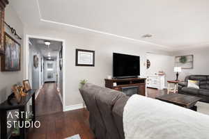 Living room with dark hardwood / wood-style flooring and a textured ceiling