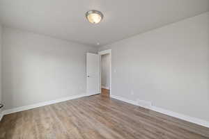 Unfurnished room with light hardwood / wood-style floors