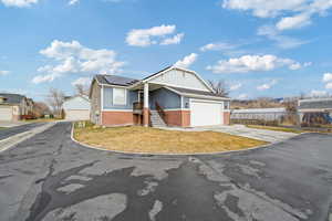 View of front of house with a garage and solar panels