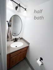 Bathroom with a textured ceiling and vanity