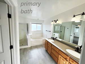 Bathroom with separate shower and tub, vanity, a textured ceiling, and hardwood / wood-style flooring