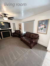 Living room with ceiling fan and a textured ceiling