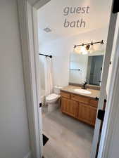 Full bathroom featuring shower / bath combo, vanity, and toilet