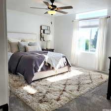 Bedroom featuring ceiling fan and carpet floors