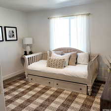 Bedroom with dark colored carpet