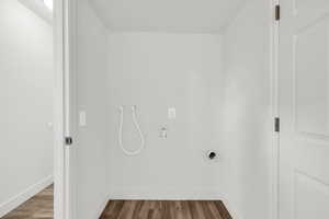 Laundry room featuring hardwood / wood-style floors