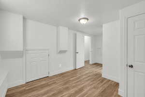 Interior space with light hardwood / wood-style floors and a textured ceiling