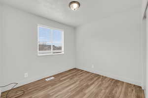 Spare room with light hardwood / wood-style flooring