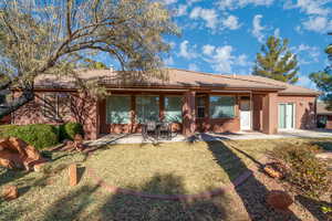 Rear view of house featuring a patio area and a yard