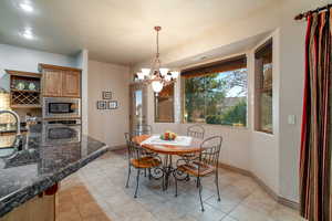 Dining room with sink and an inviting chandelier