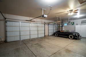 Garage featuring ceiling fan and a garage door opener