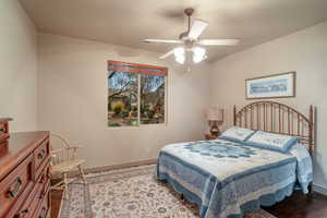 Bedroom with hardwood / wood-style flooring and ceiling fan