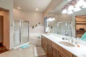 Bathroom with separate shower and tub, tile patterned floors, and vanity