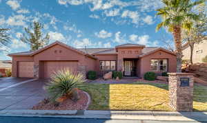 Mediterranean / spanish-style house featuring a front yard and a garage