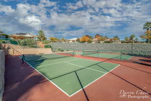 View of tennis/pickleball court with basketball hoop