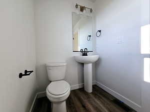 Bathroom with wood-type flooring and toilet