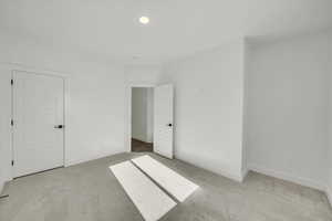 Unfurnished bedroom with light carpet