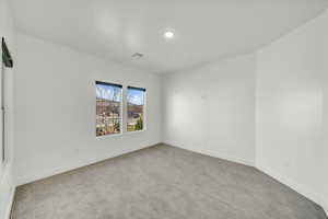 Unfurnished room featuring light colored carpet