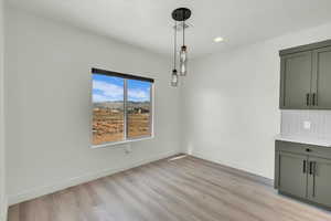 Unfurnished dining area with light hardwood / wood-style flooring