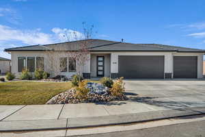 Prairie-style home featuring a front lawn and a garage