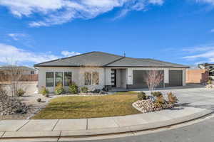 View of front of house with a front lawn and a garage