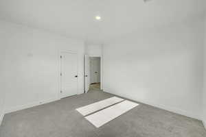 Unfurnished room with light colored carpet