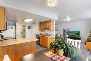 Kitchen featuring dark hardwood / wood-style floors, stainless steel dishwasher, and sink