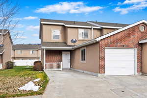 View of front property with a garage and a front lawn