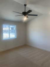 Carpeted spare room with ceiling fan