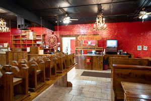 Kitchen featuring ceiling fan with notable chandelier