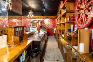 Interior space with tile patterned flooring and an inviting chandelier