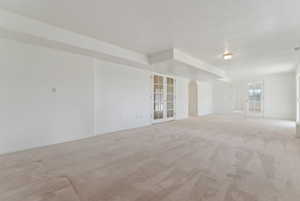 Spare room with french doors and light colored carpet