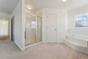 Bathroom featuring shower with separate bathtub