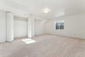 Unfurnished bedroom with light carpet