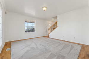 Spare room with light hardwood / wood-style floors and ornamental molding